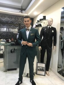 Novio modelando un exclusivo traje verde esmeralda.